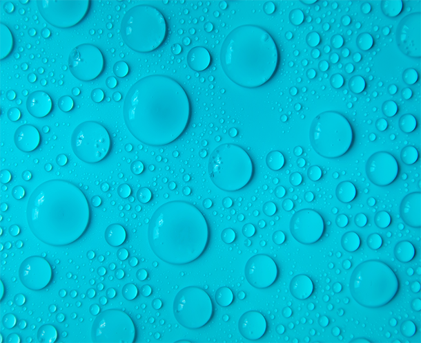 A close up of water droplets on a blue surface.